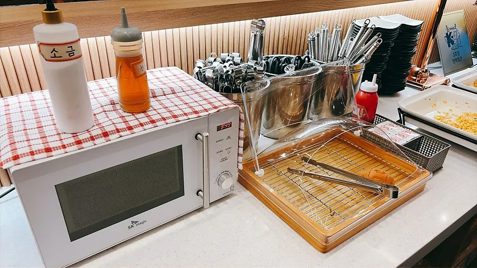 Salad bar with dinner rolls and strawberry jam