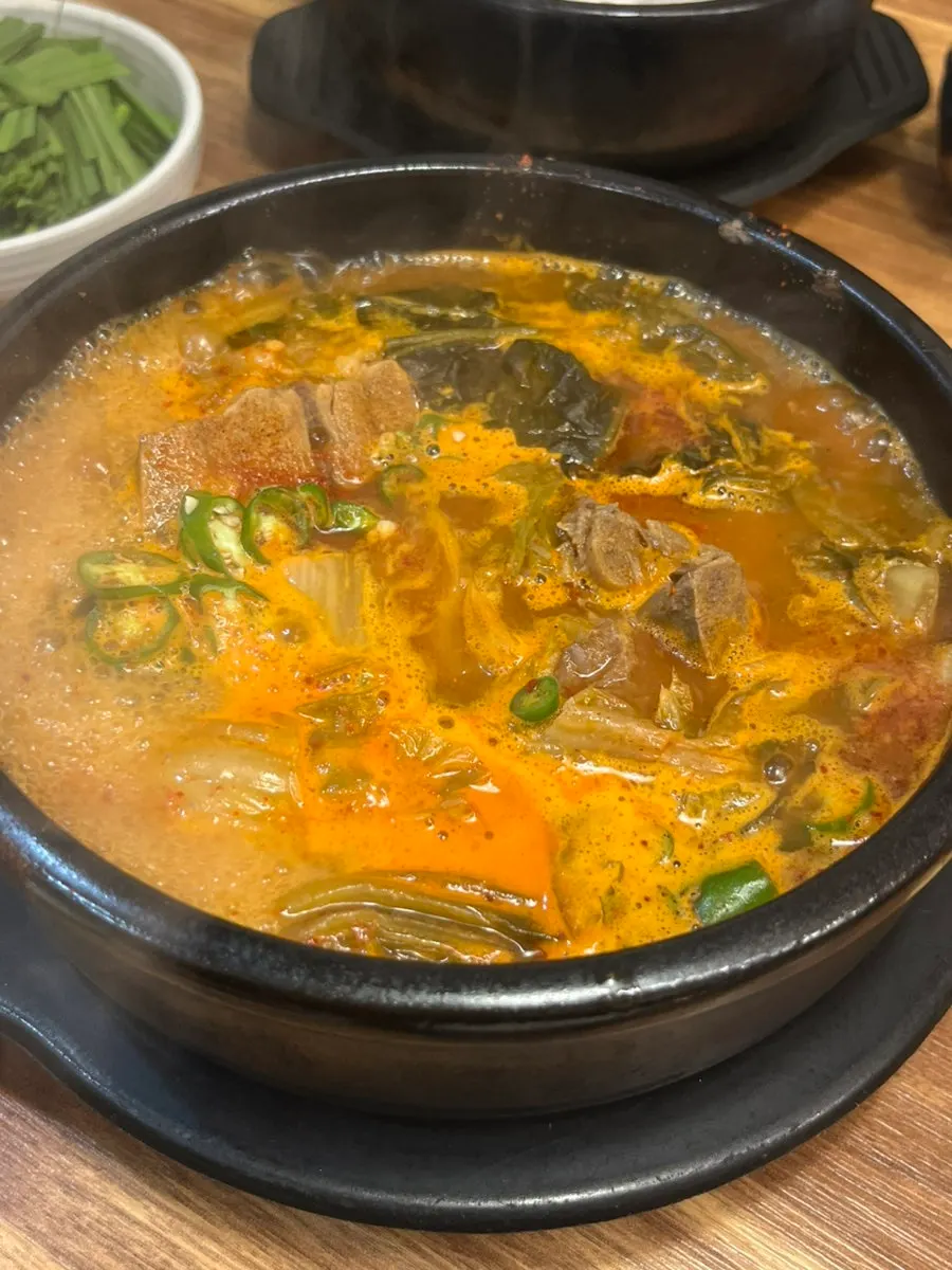 Stone bowl of spicy ppyeo-haejangguk full of meat