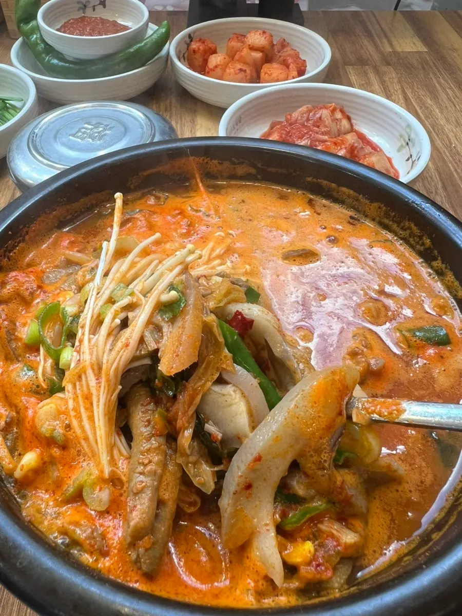 Broth full of bean sprouts and meat