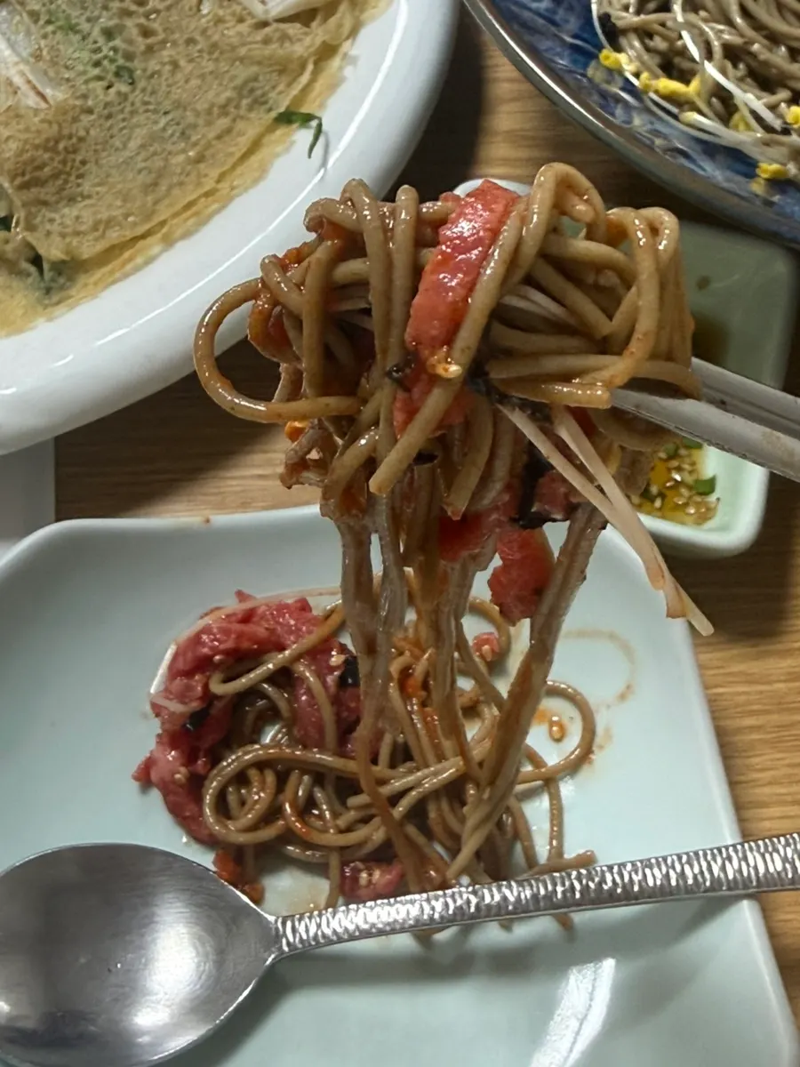 A bowl of mixed raw beef bibim noodles