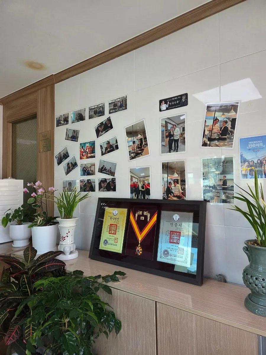 Plaques and TV appearance credits displayed at Bongpyeong Memil Migayeon