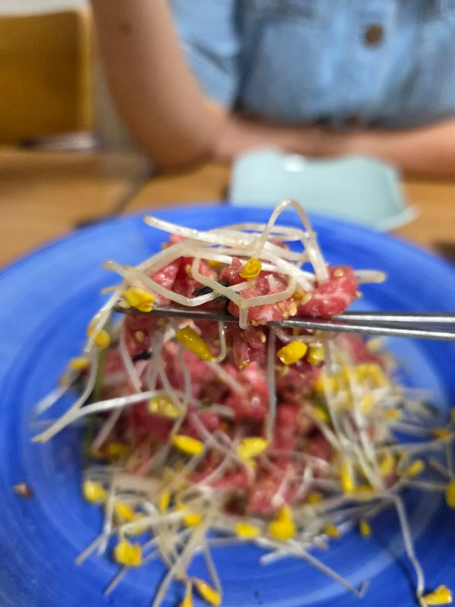 Hanwoo beef tartare mixed with sauce and buckwheat sprouts