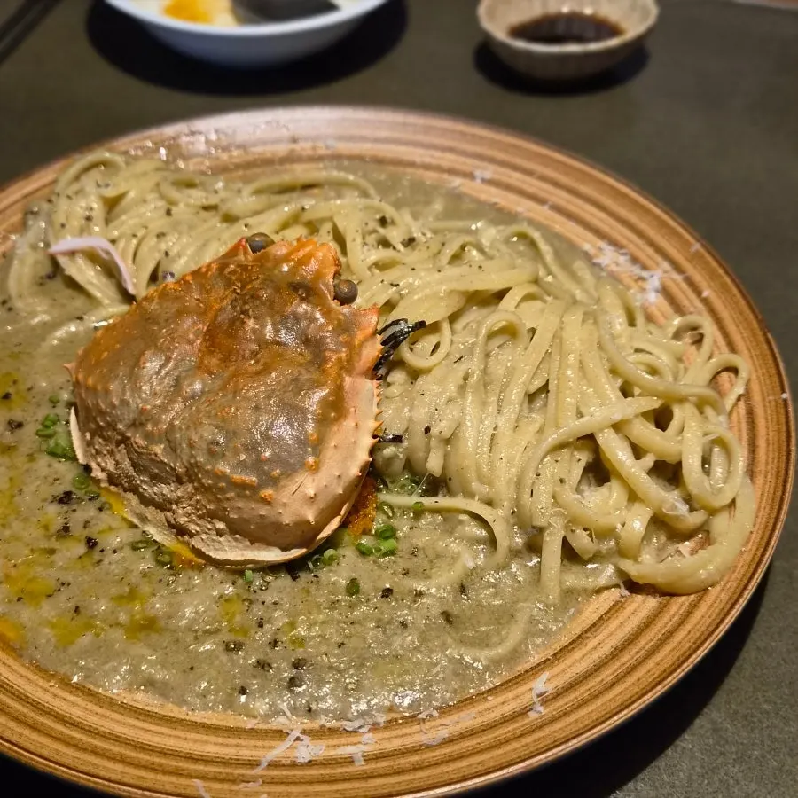 Kani miso pasta topped with a crab shell