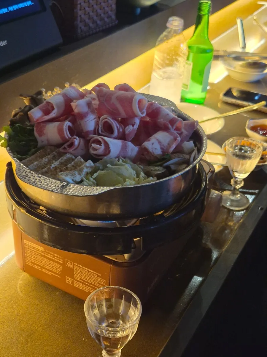 Sukiyaki pot topped with beef and mushrooms