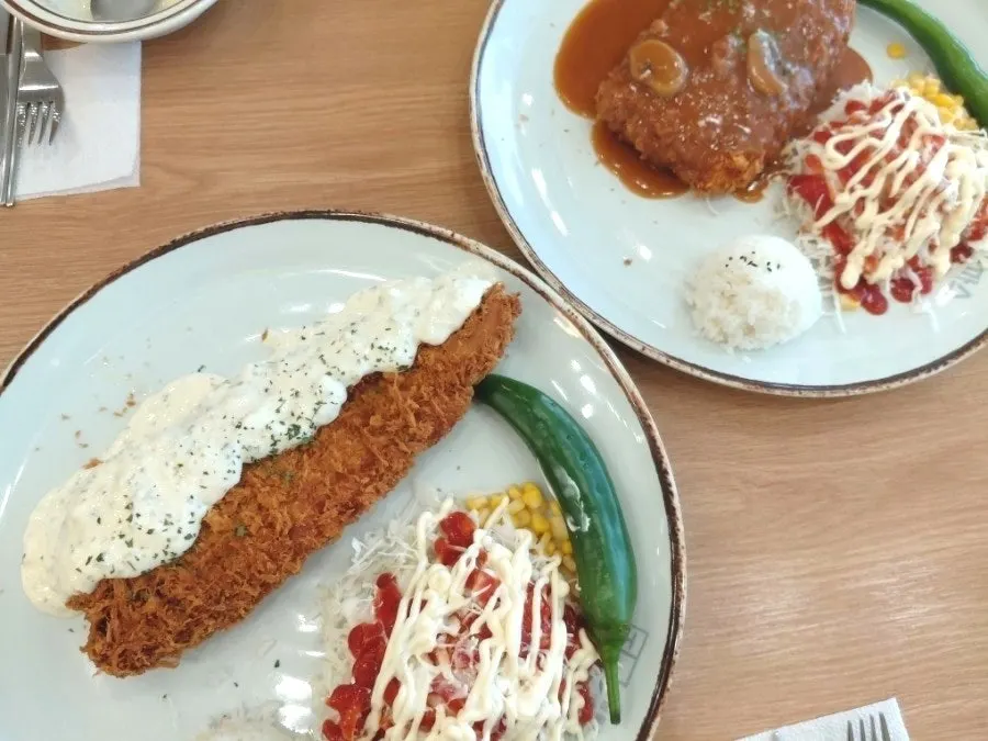 Two plates piled high with donkatsu