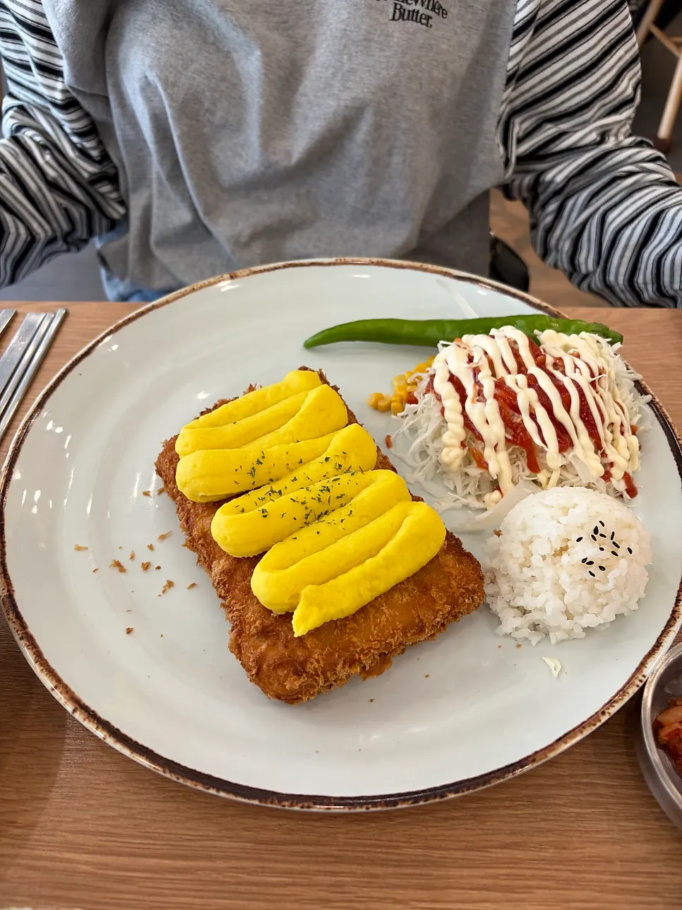 Cucumber peppers served alongside the donkatsu