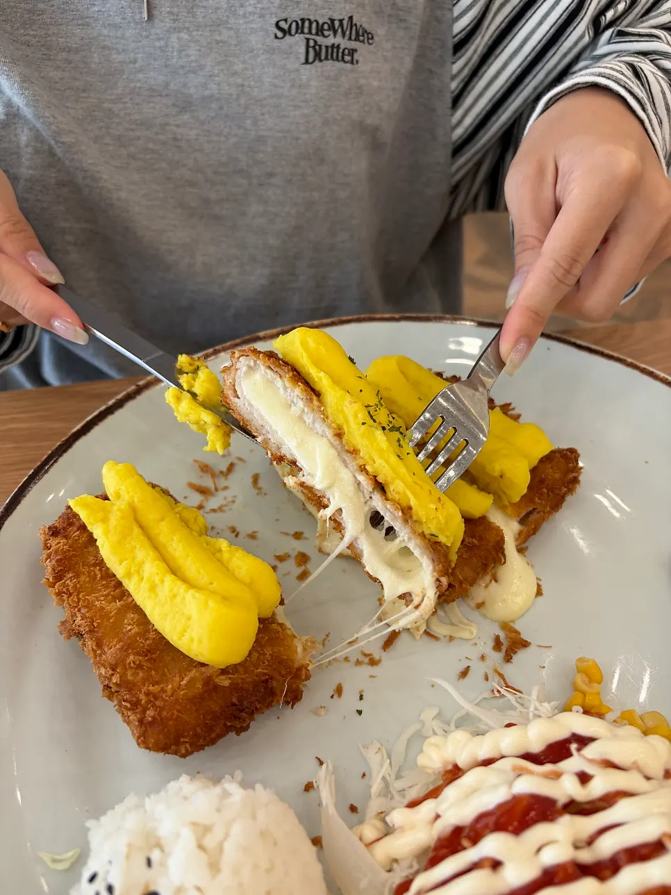 Cross-section of sweet potato cheese donkatsu with melted cheese
