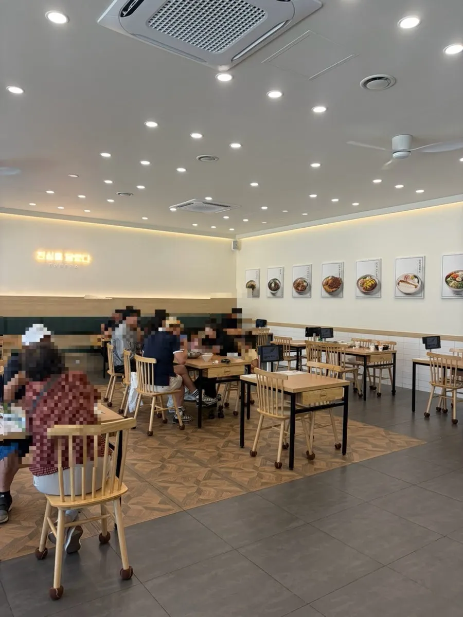 Interior of Jinsim King Donkatsu Pyeongdong Branch crowded with lunchtime customers