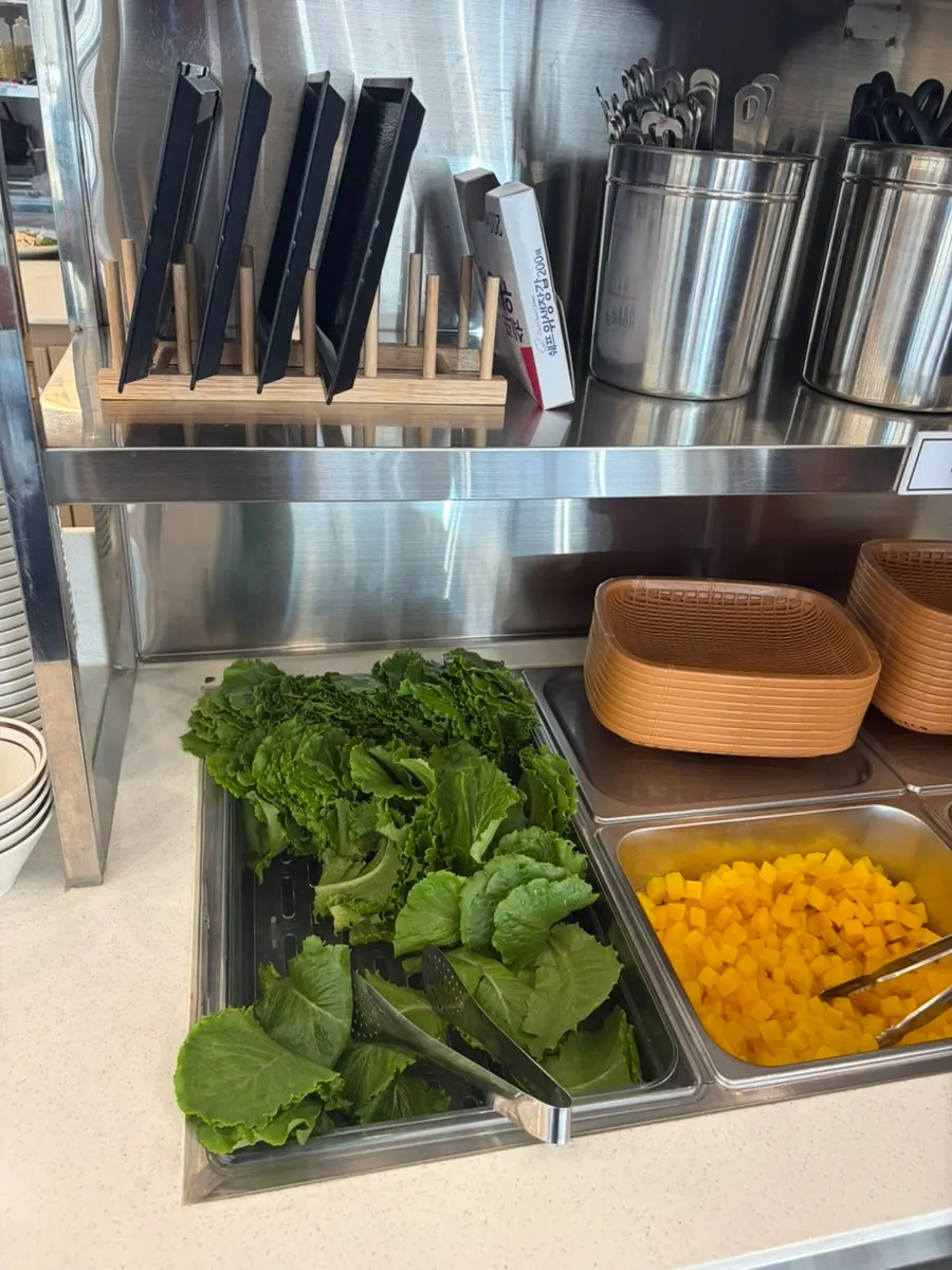 Plate of soup and side dishes gathered from the self-serve bar