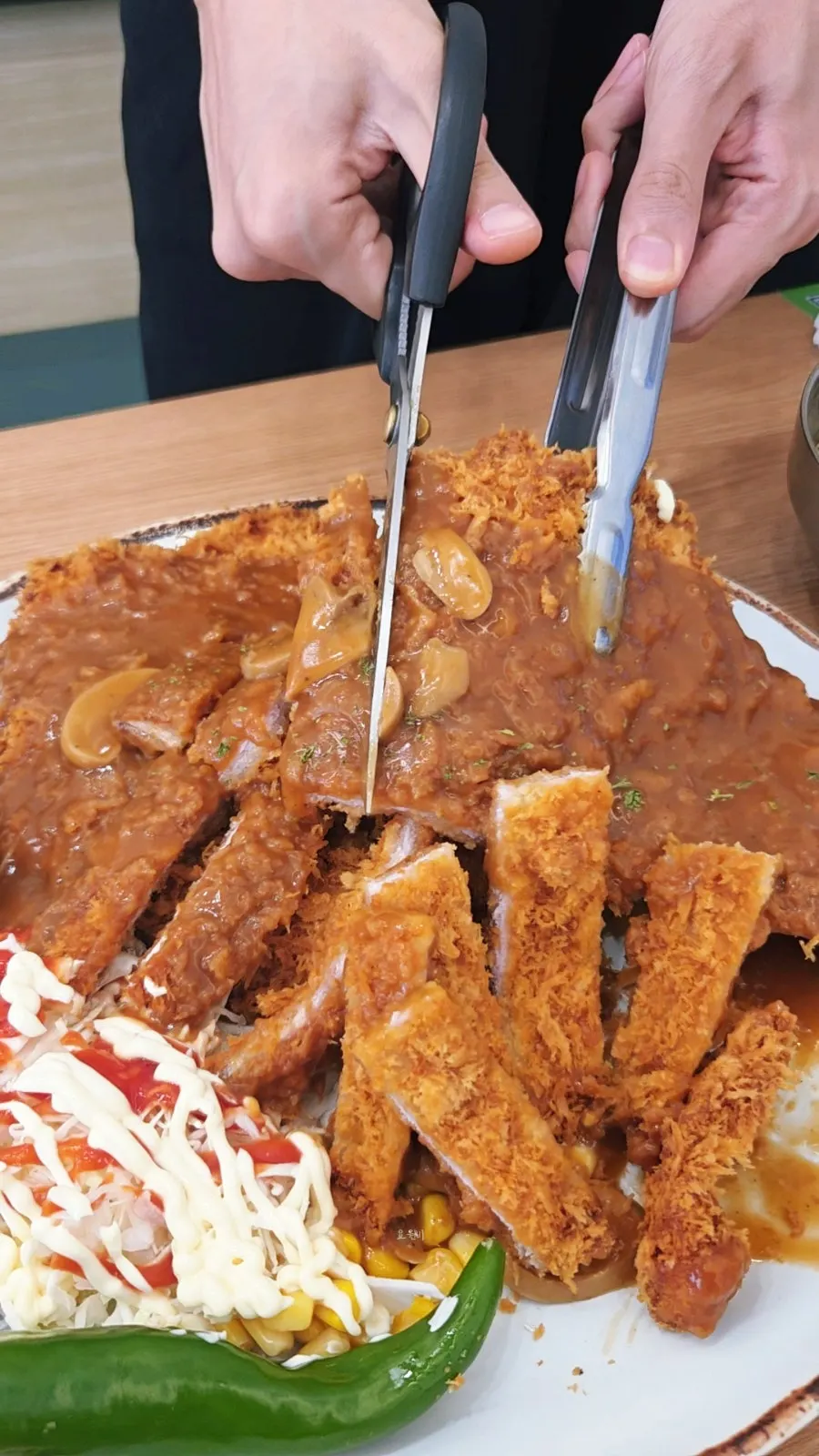 A plate of king donkatsu with sauce poured on top