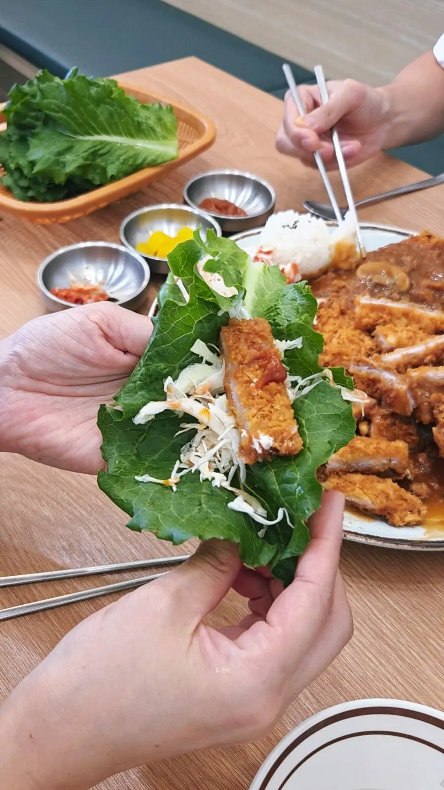 Donkatsu lettuce wrap topped with cabbage
