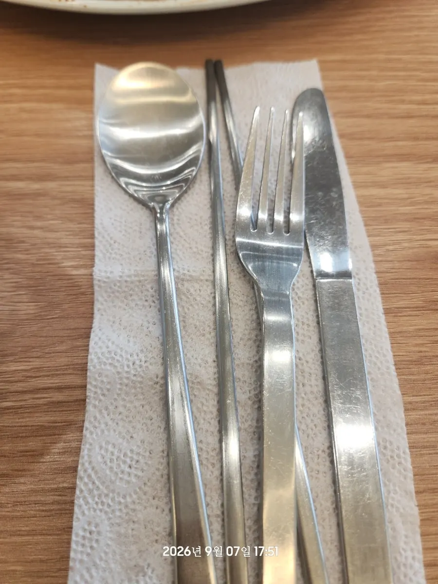 Self-serve side dishes with neatly placed spoons and chopsticks
