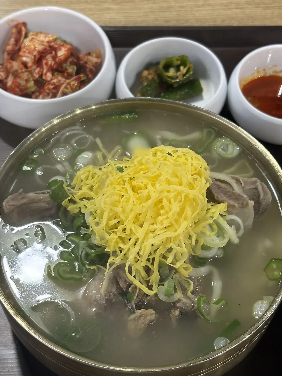Close-up of the clear broth in the bone kalguksu