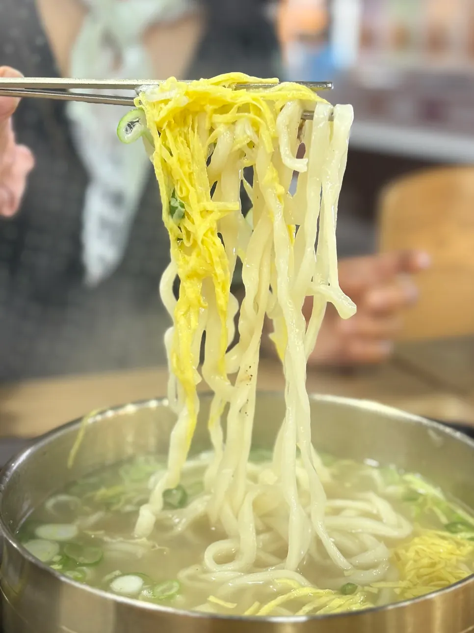 Noodles lifted together with egg garnish