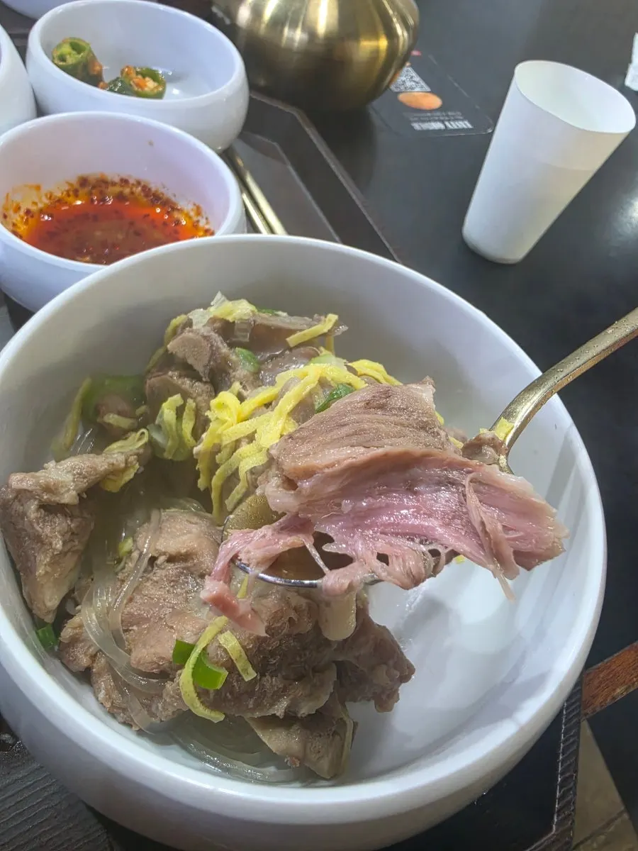 Bone kalguksu acompañado de salsa de aceite de chile