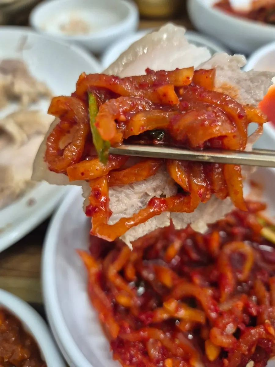A piece of pork on radish salad