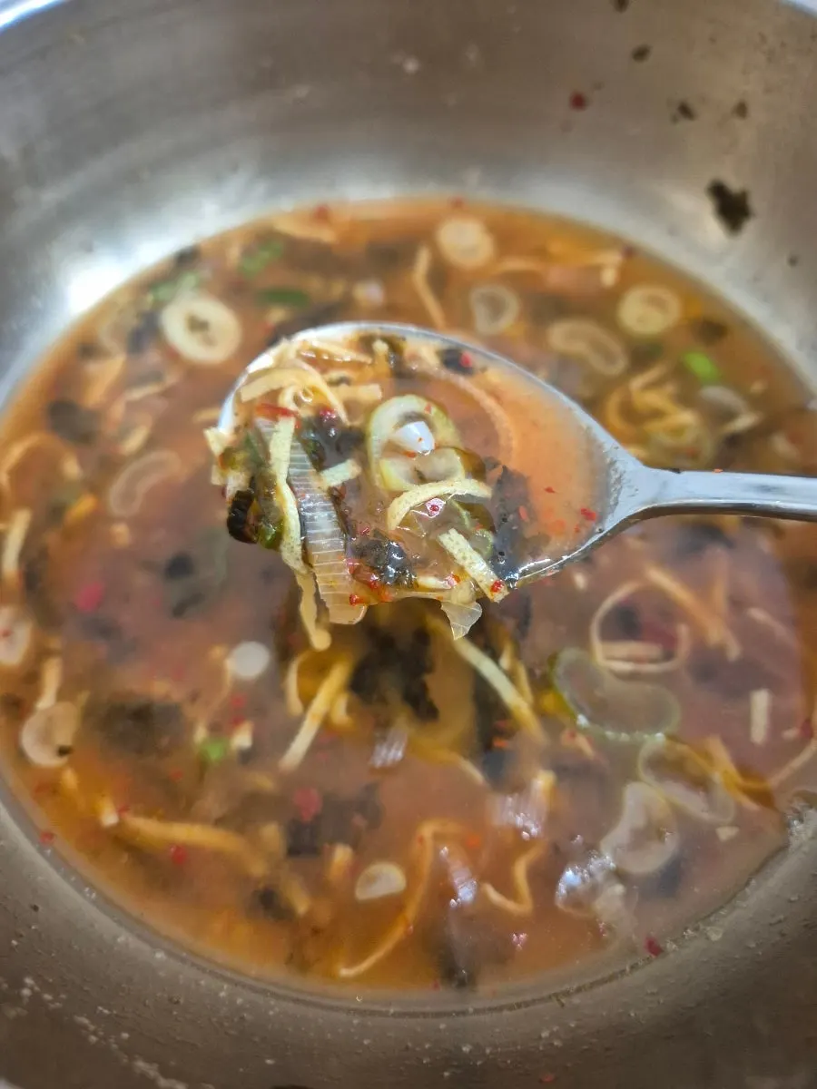 Kalguksu noodles lifted up with chopsticks
