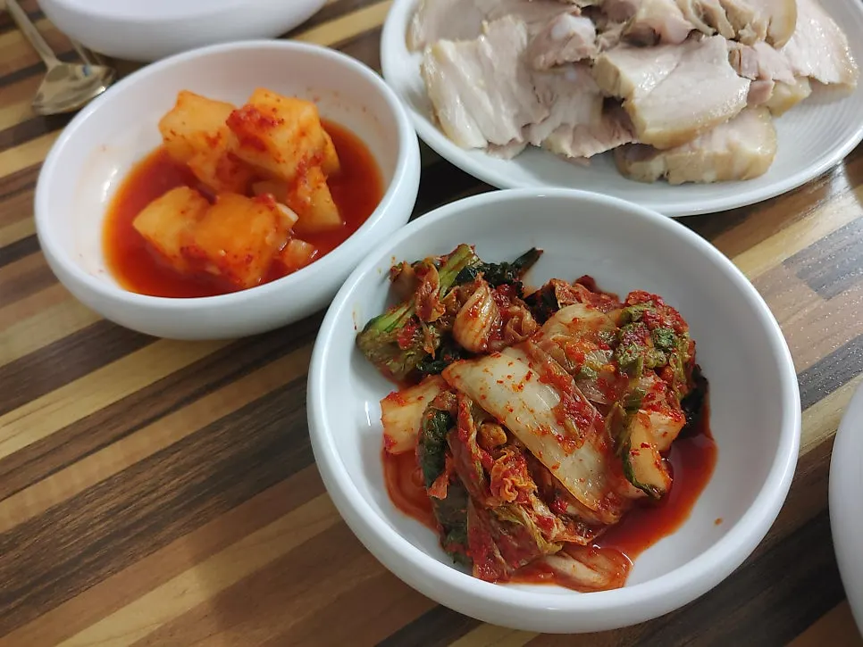 Table setting with cabbage leaves, garlic, and ssamjang