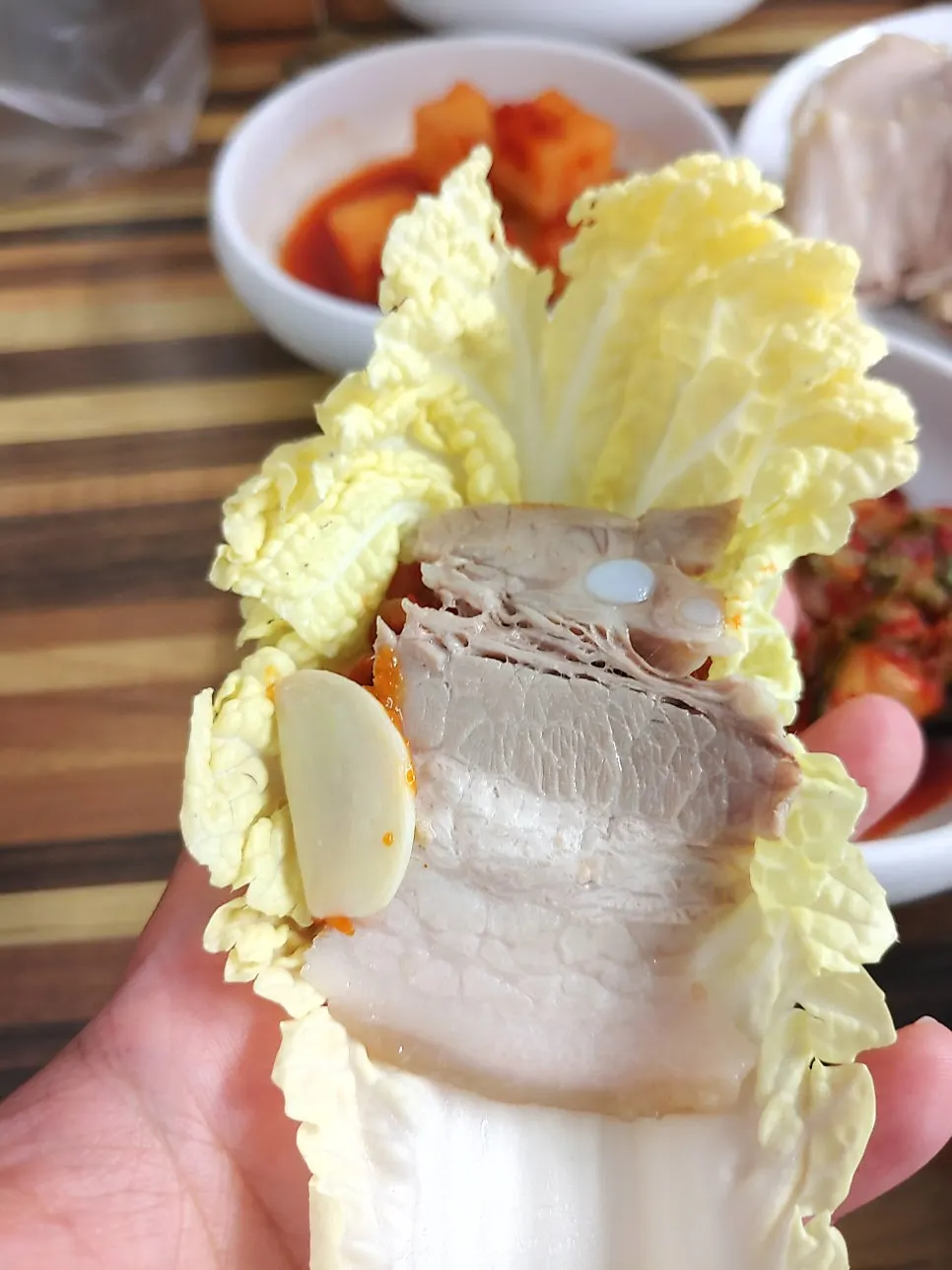 Cabbage wrap topped with meat and kimchi