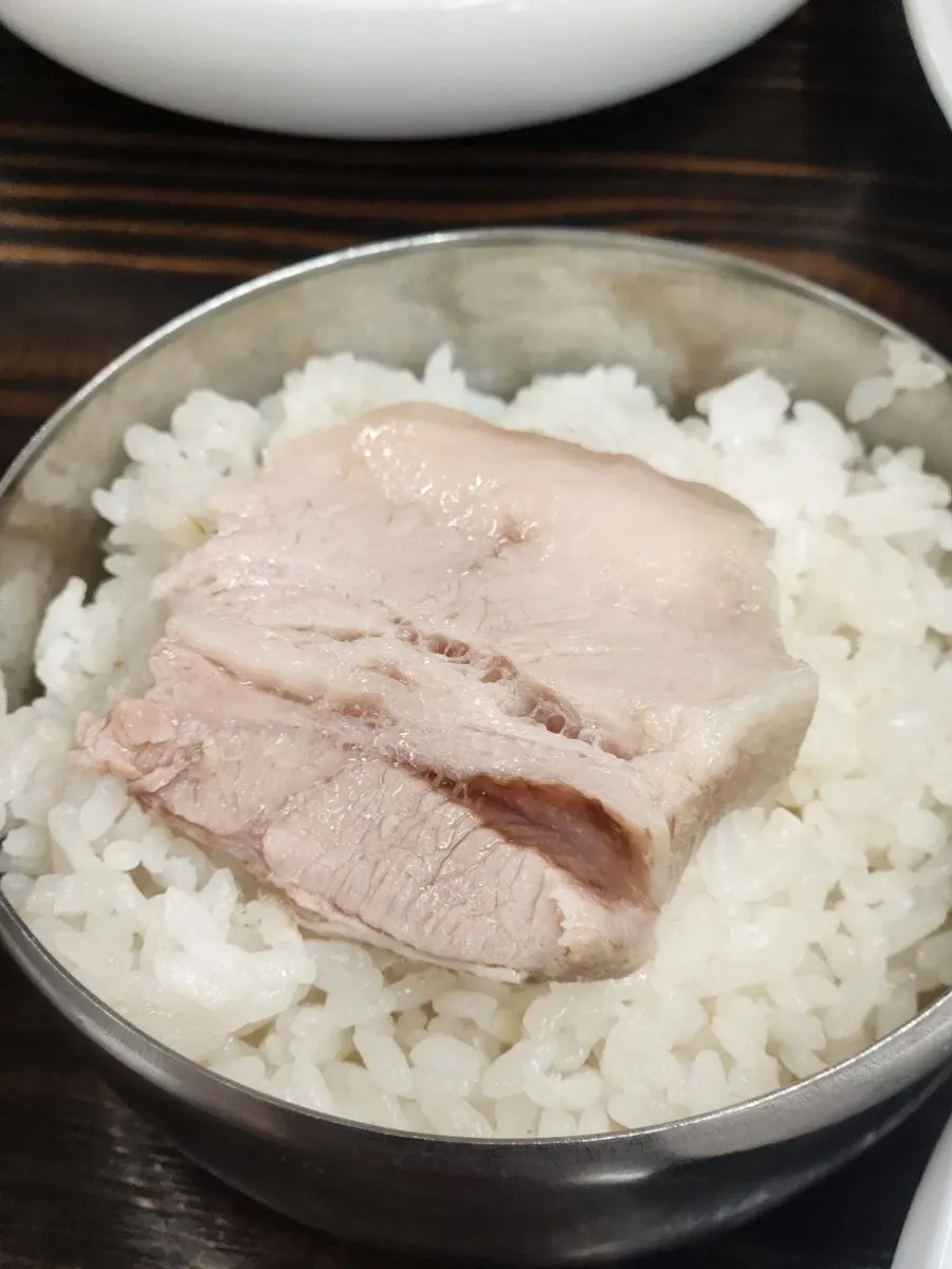 Bossam eaten together with a bowl of rice