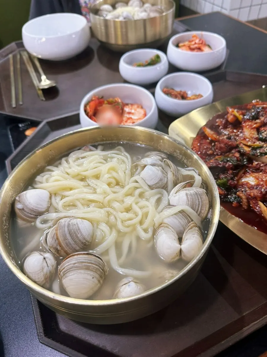 Clam kalguksu broth packed with clams