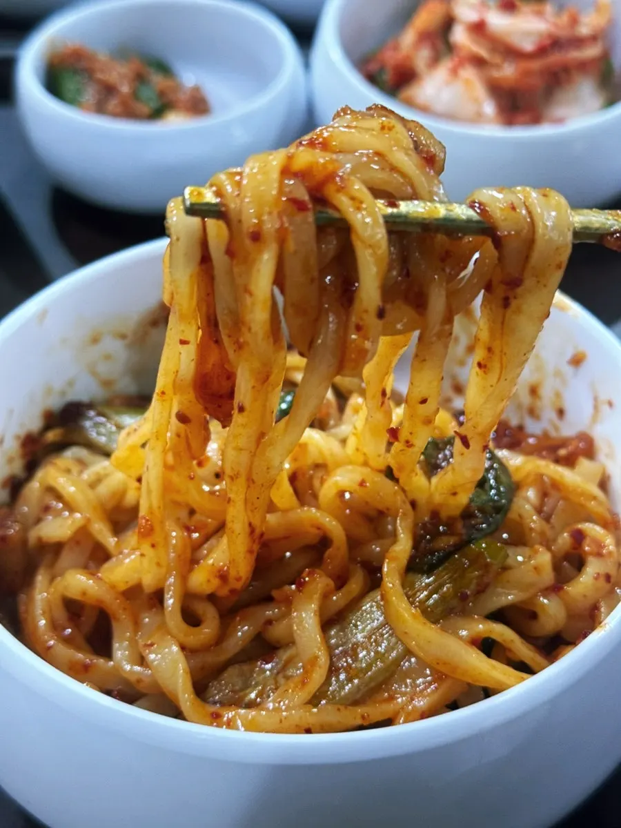 Kalguksu noodles mixed into octopus stir-fry sauce