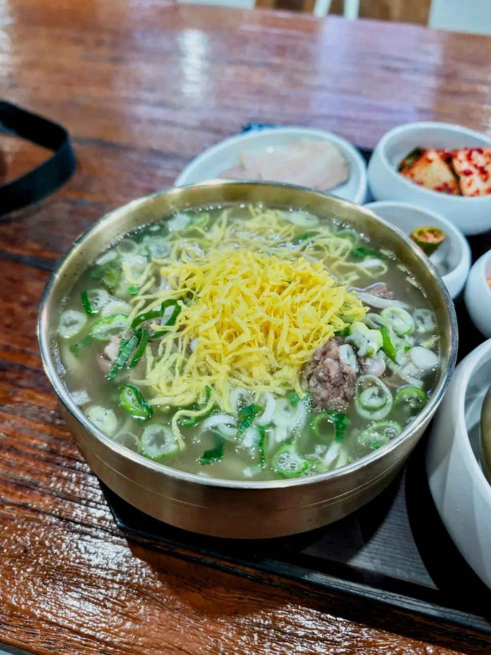 A bowl of bone kalguksu topped with egg garnish