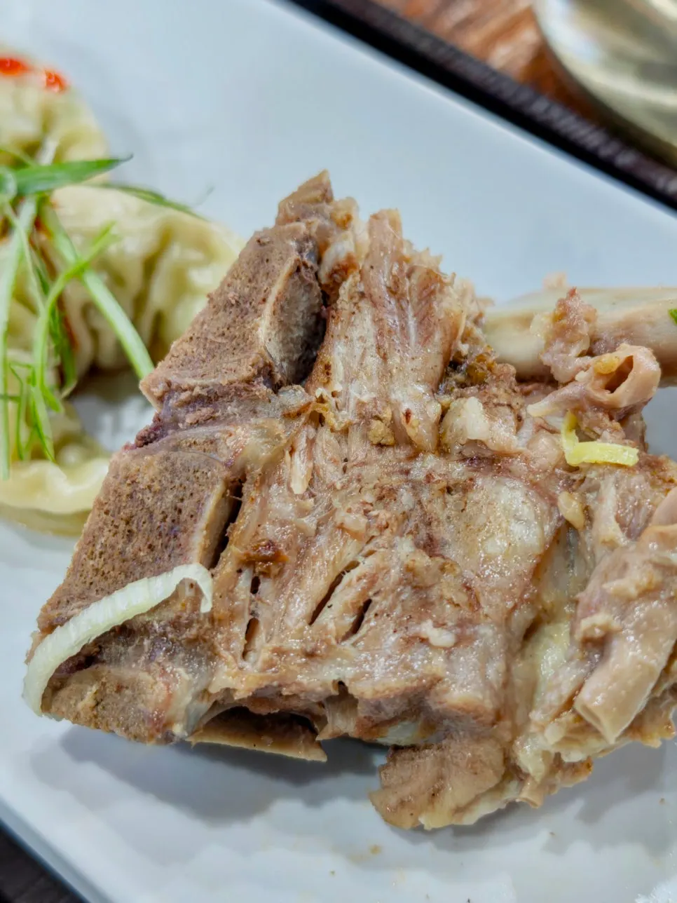 Pork neck bone revealed after moving aside the egg garnish