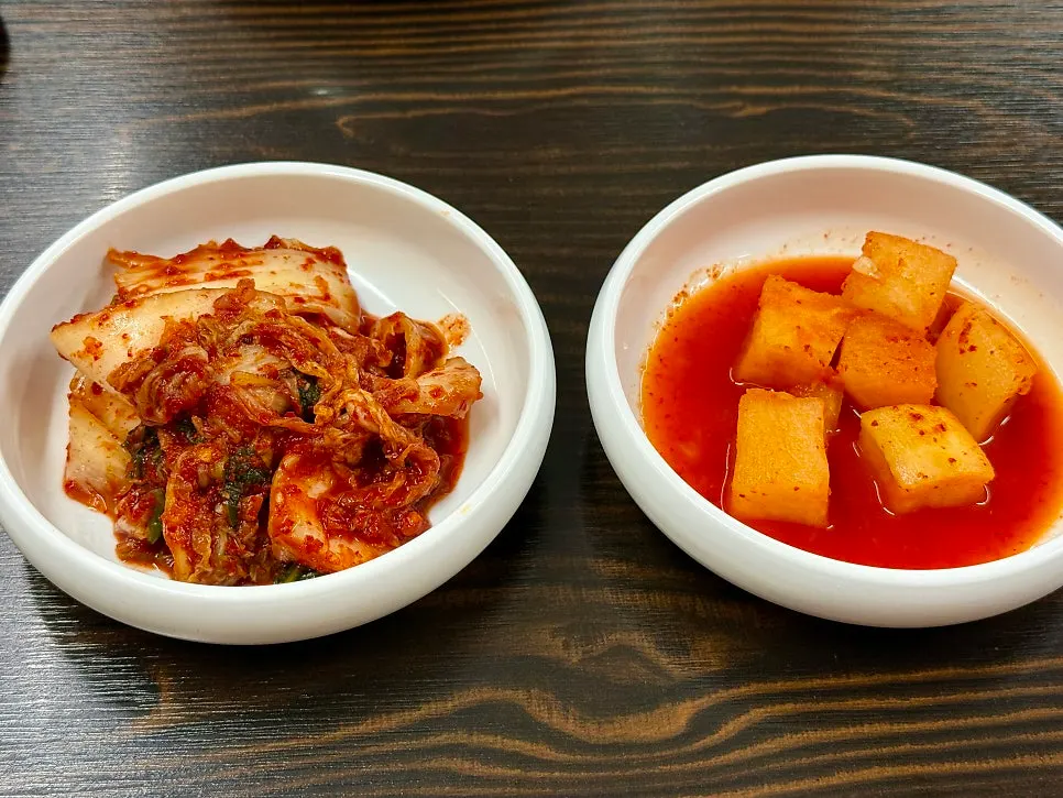 Napa cabbage kimchi and kkakdugi side dishes served first