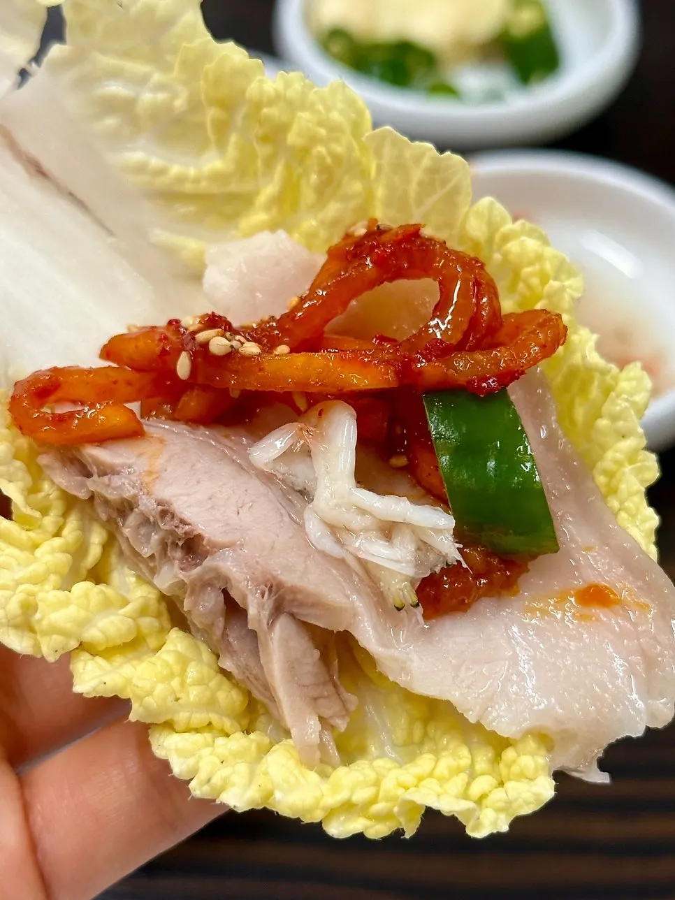 Bossam pork and radish kimchi over baby napa cabbage