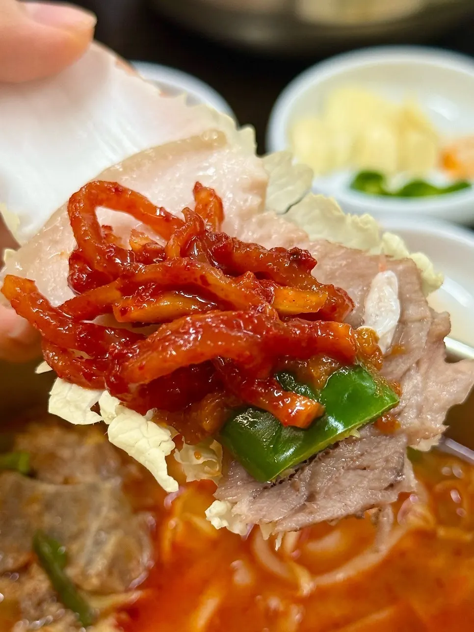 A wrap with salted shrimp and ssamjang-dipped chili
