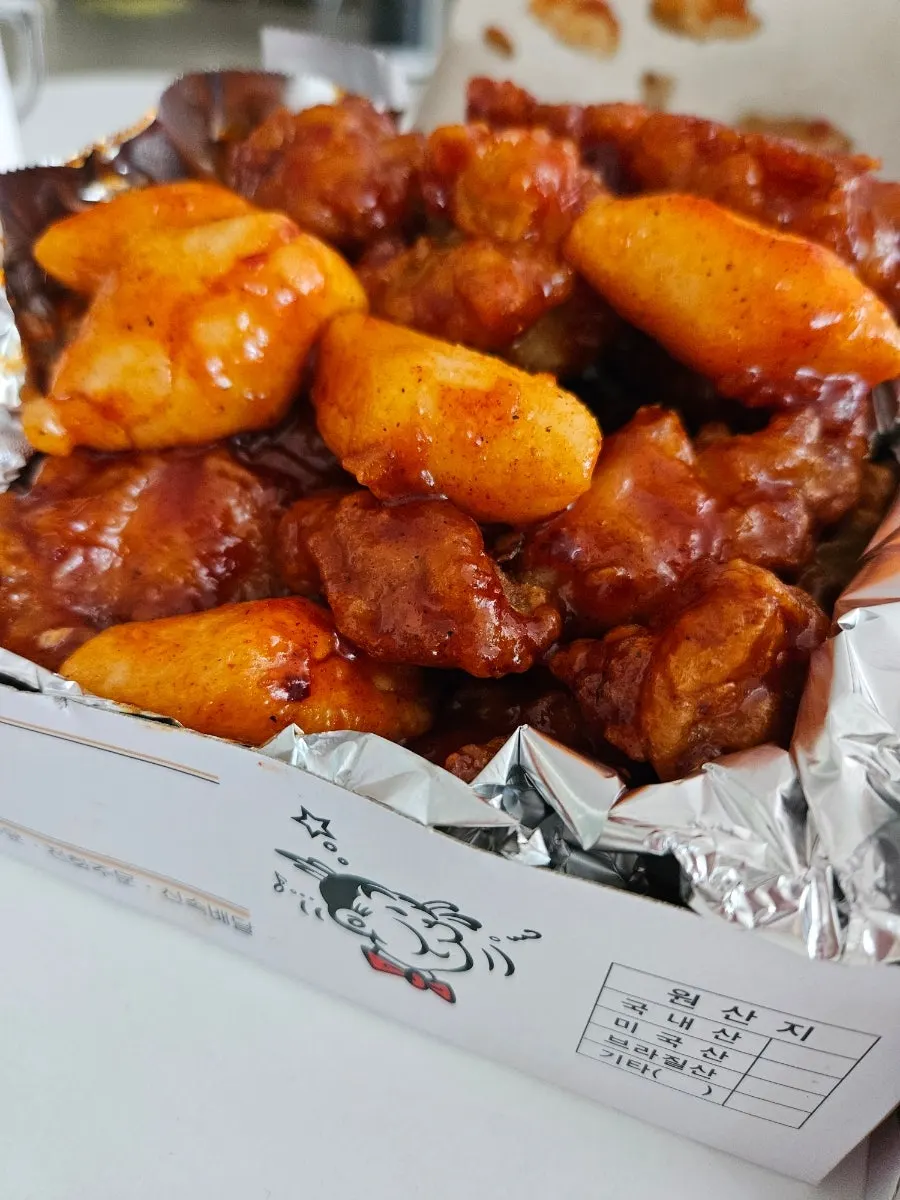 Close-up of double-fried dakgangjeong tossed in sauce