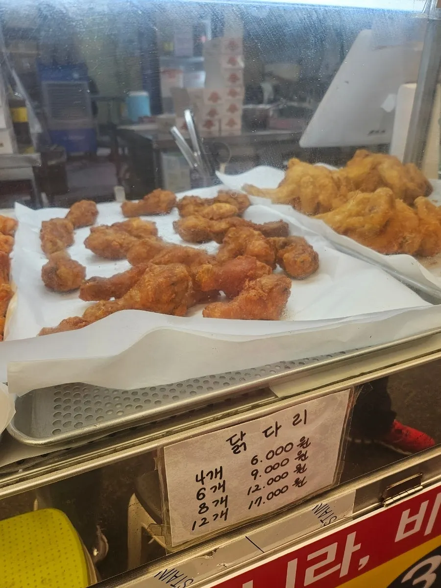 Menu board showing old-style whole chicken at 7,000 won