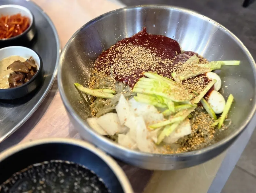 Bibim naengmyeon served with grilled meat