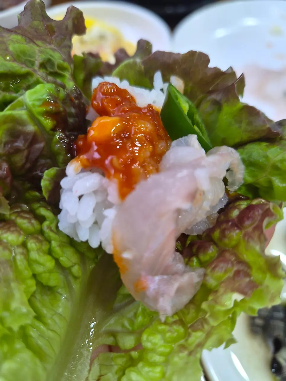 Lettuce wrap topped with sashimi and ssamjang