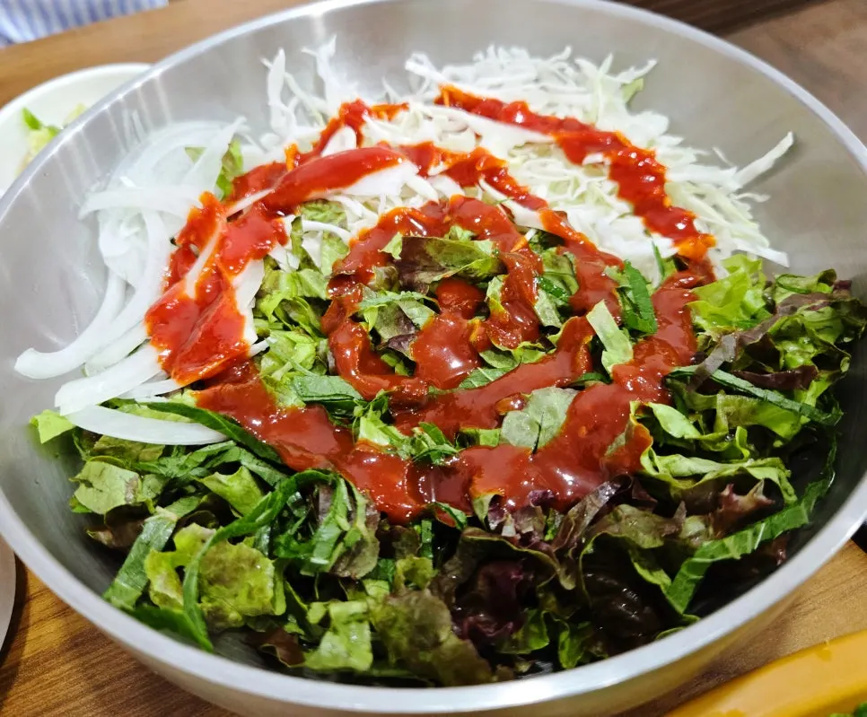 A large bowl full of julienned vegetables