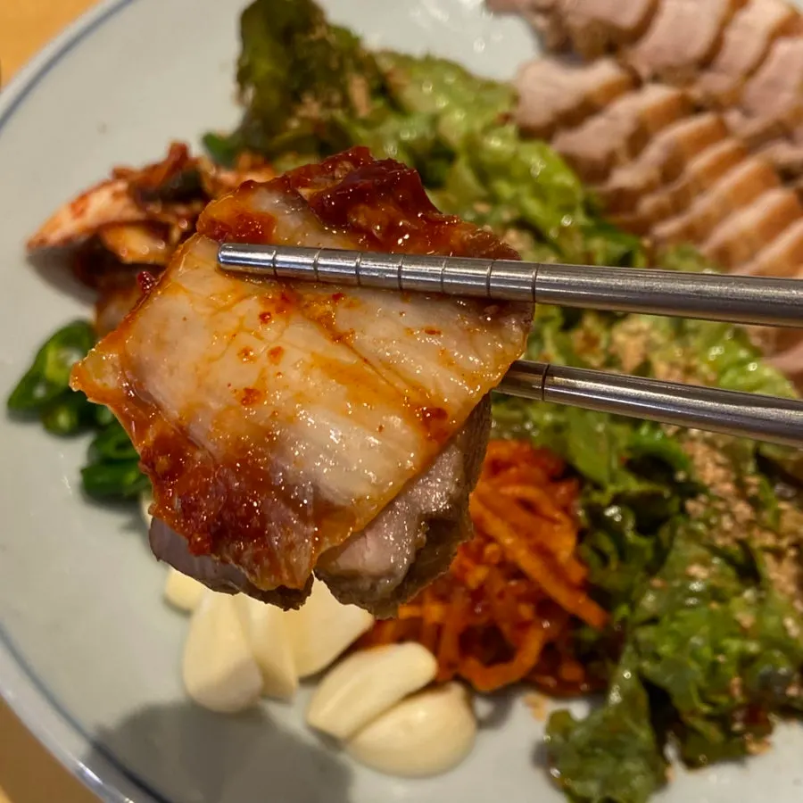 A thinly sliced piece of bossam pork