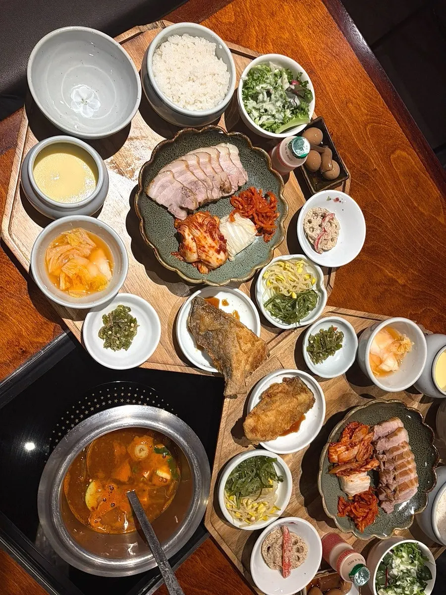 Bossam served with side dishes on the set table