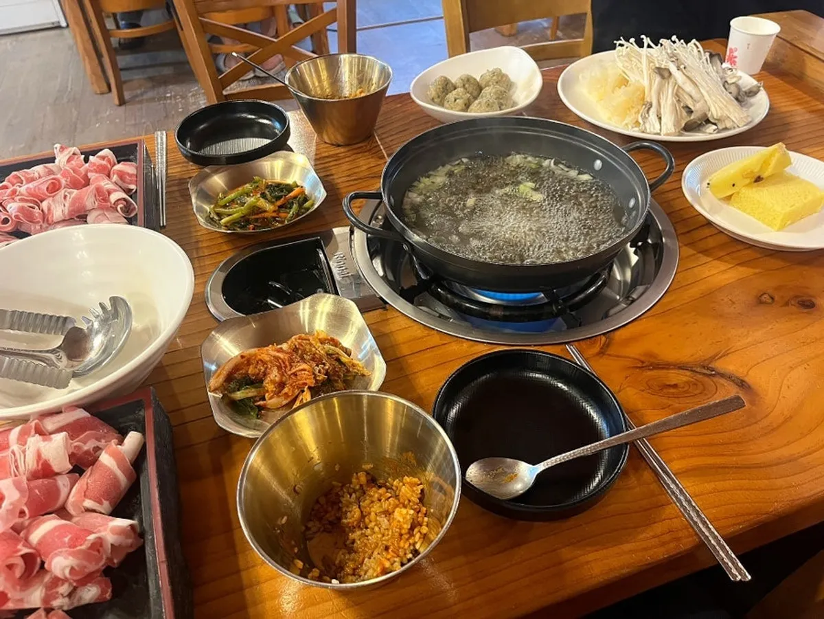 Beef kalguksu hot pot table setting at Songdam Kalguksu