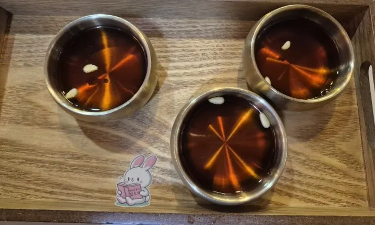 Plum tea dessert topped with pine nuts