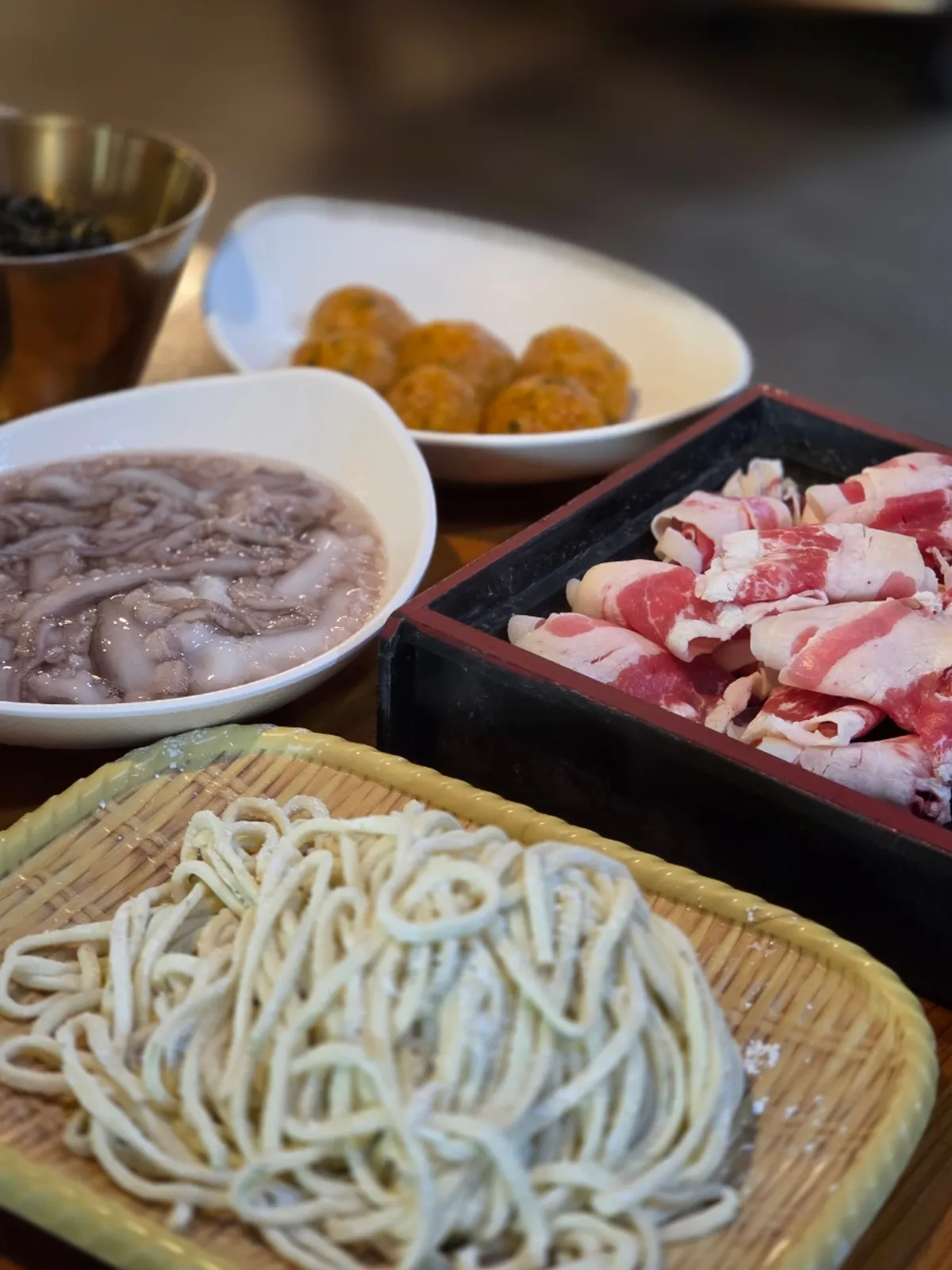 Octopus kalguksu jeongol served with added beef and kimchi wanja mandu