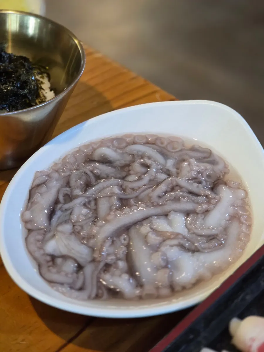 Octopus kalguksu jeongol bubbling away at the table