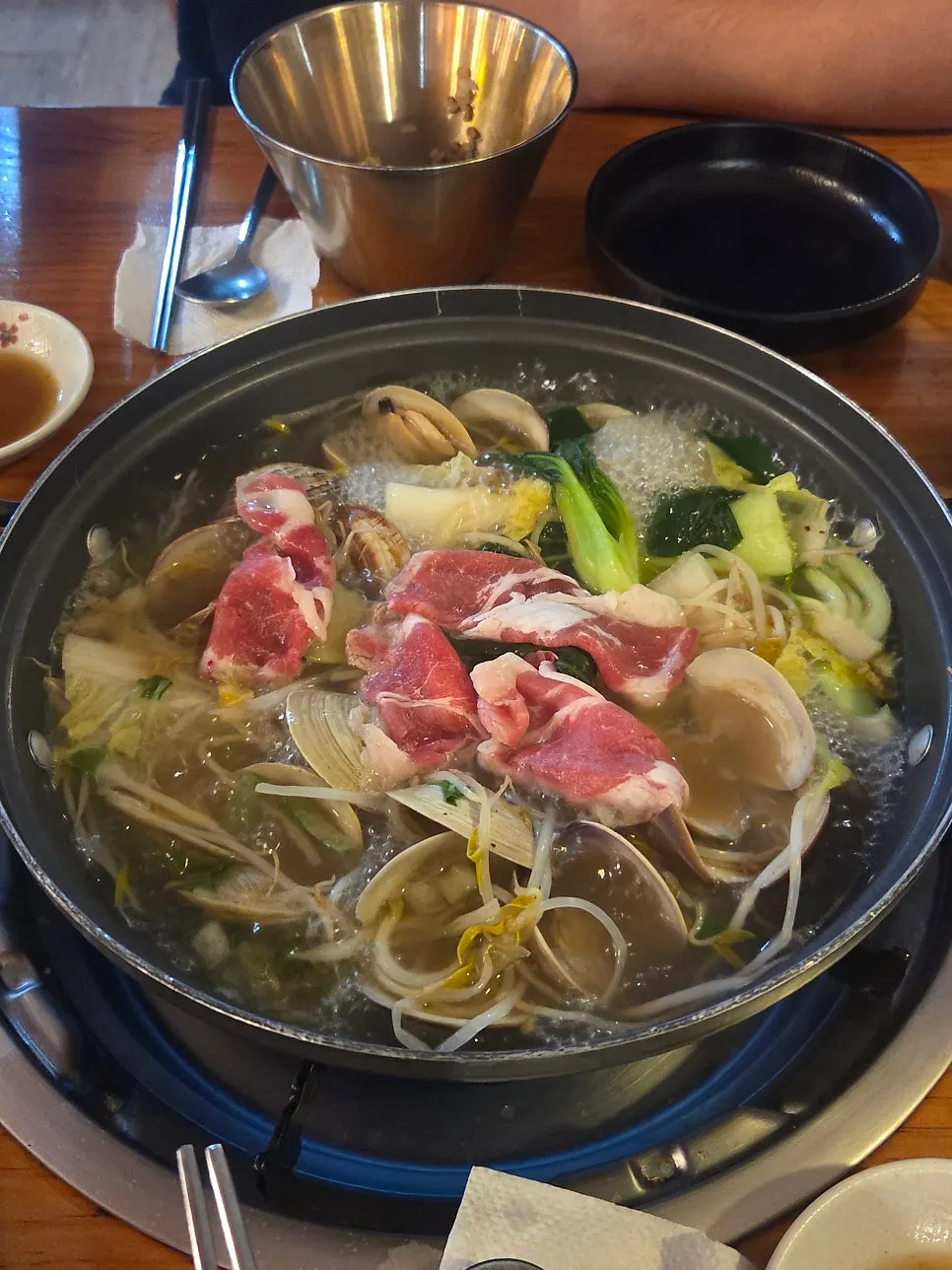Cooked beef being lifted out of the pot