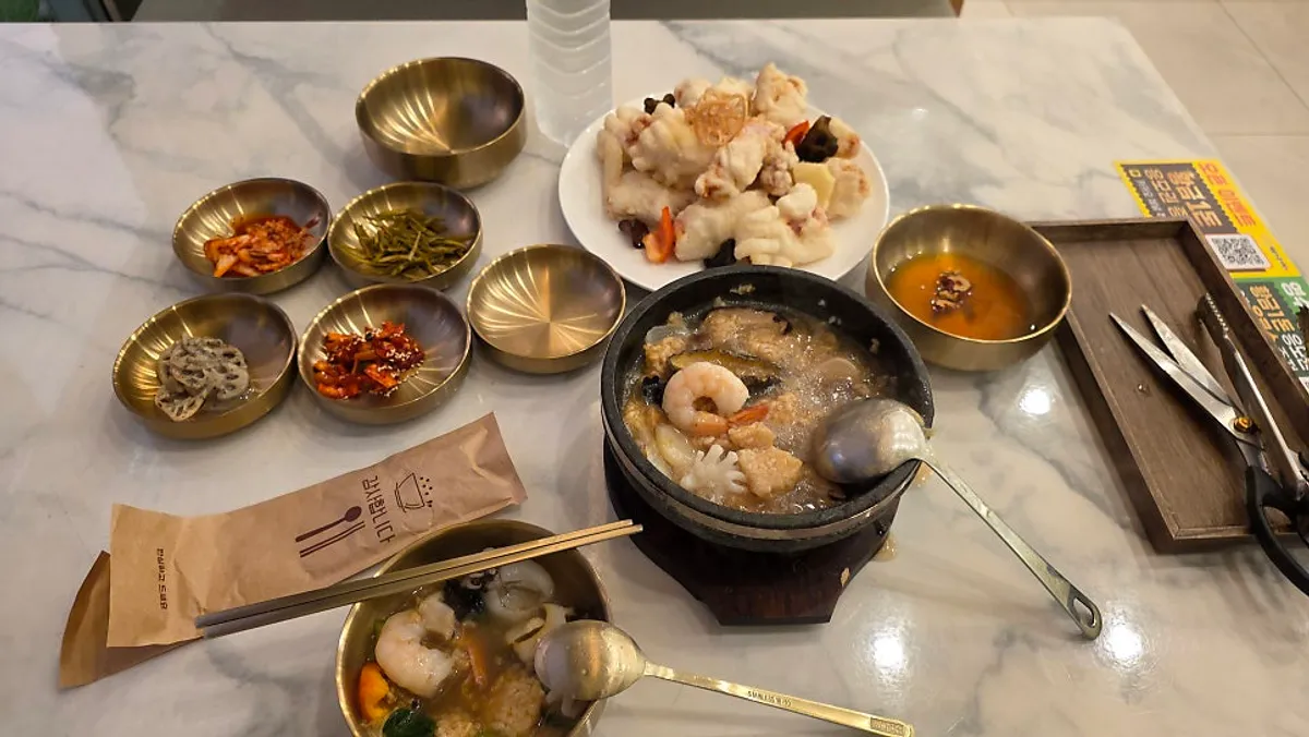 Seafood nurungji-tang boiling in a stone pot