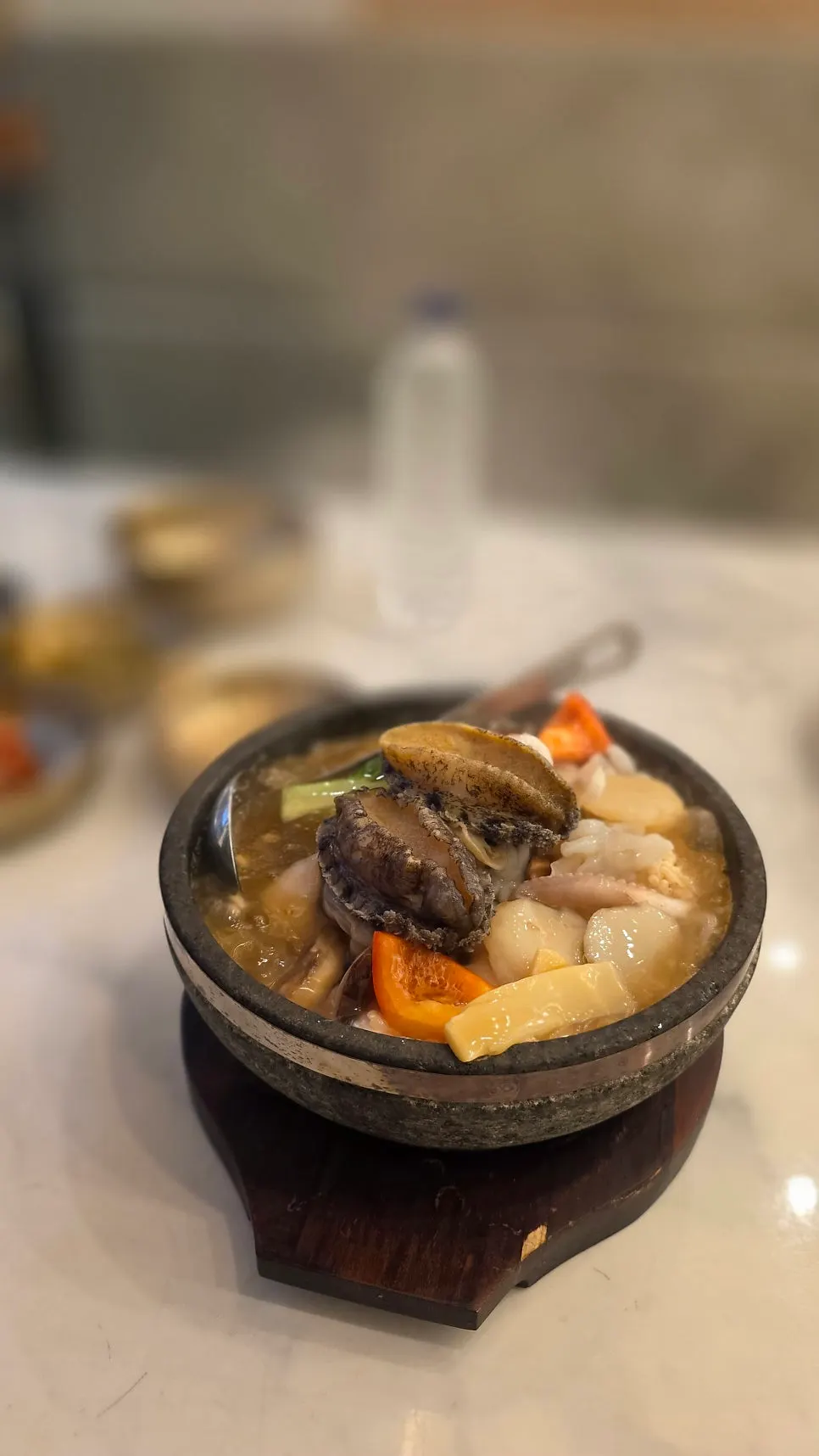A spoonful of broth-soaked nurungji