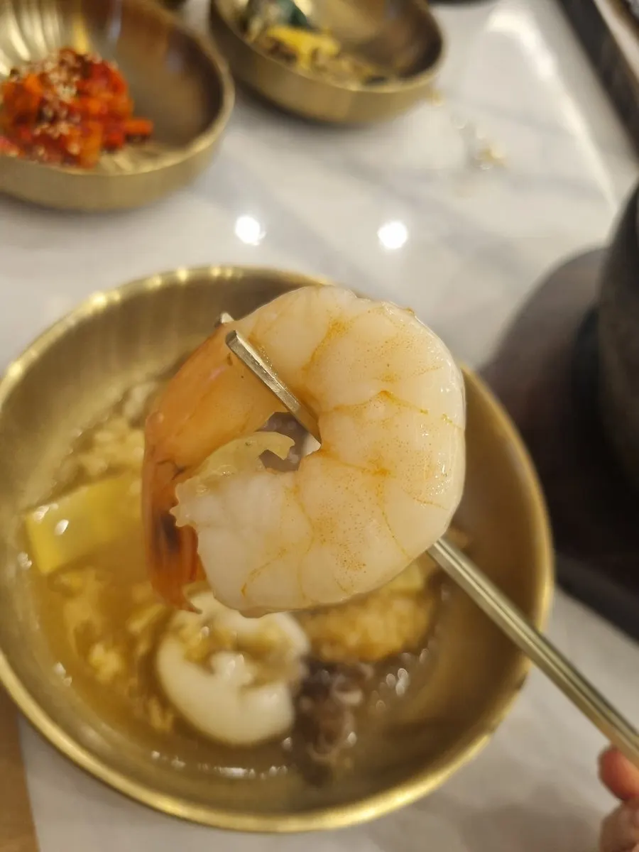 A spoonful of broth-soaked, softened nurungji