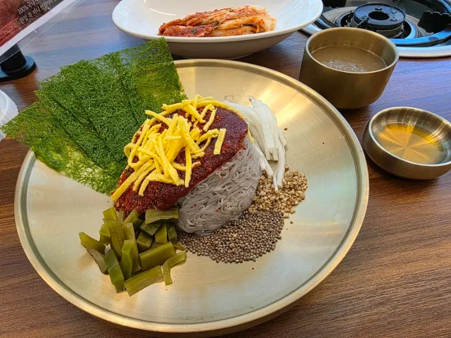 A bowl of bibim goldongmyeon served with gamtae
