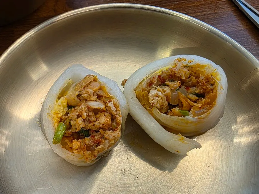 Napa cabbage dumplings served in a steamer basket