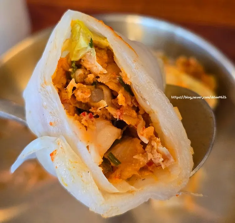 Close-up of dumpling filling wrapped in napa cabbage