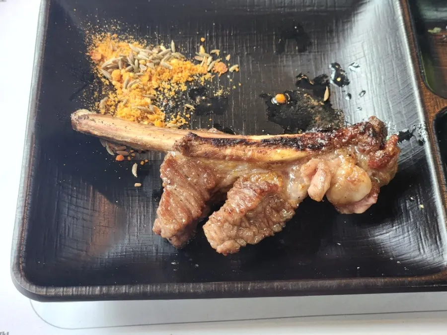 Staff member grilling shoulder rack
